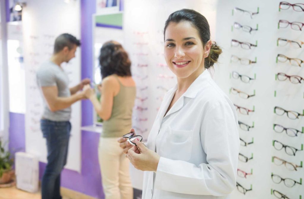 Optician helping patient choose the right children's glasses