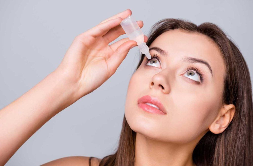 woman applying prescription eye drops