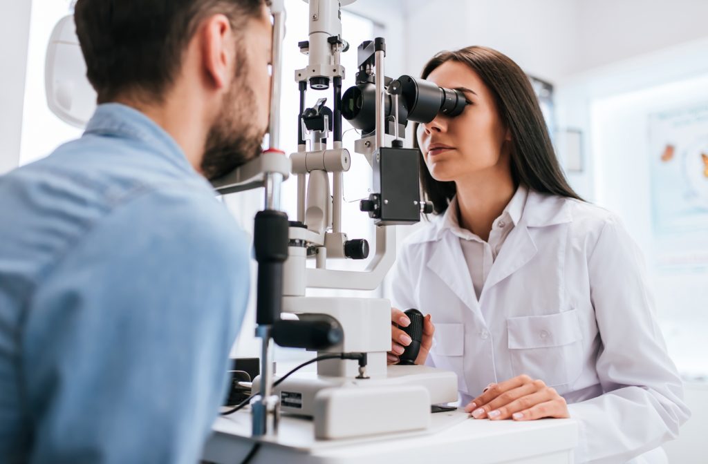 Optometrist performing a regular eye exam on a patient